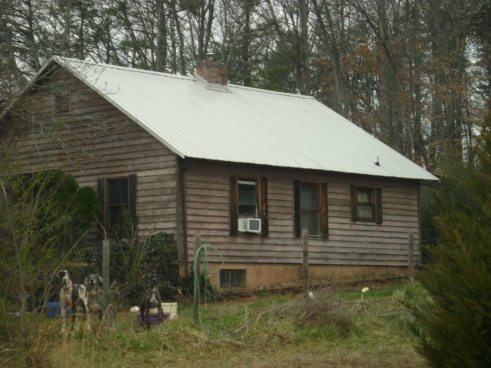 White metal roof on an old wood sided farmhouse, from a Metal Roof Installation job in Macedonia